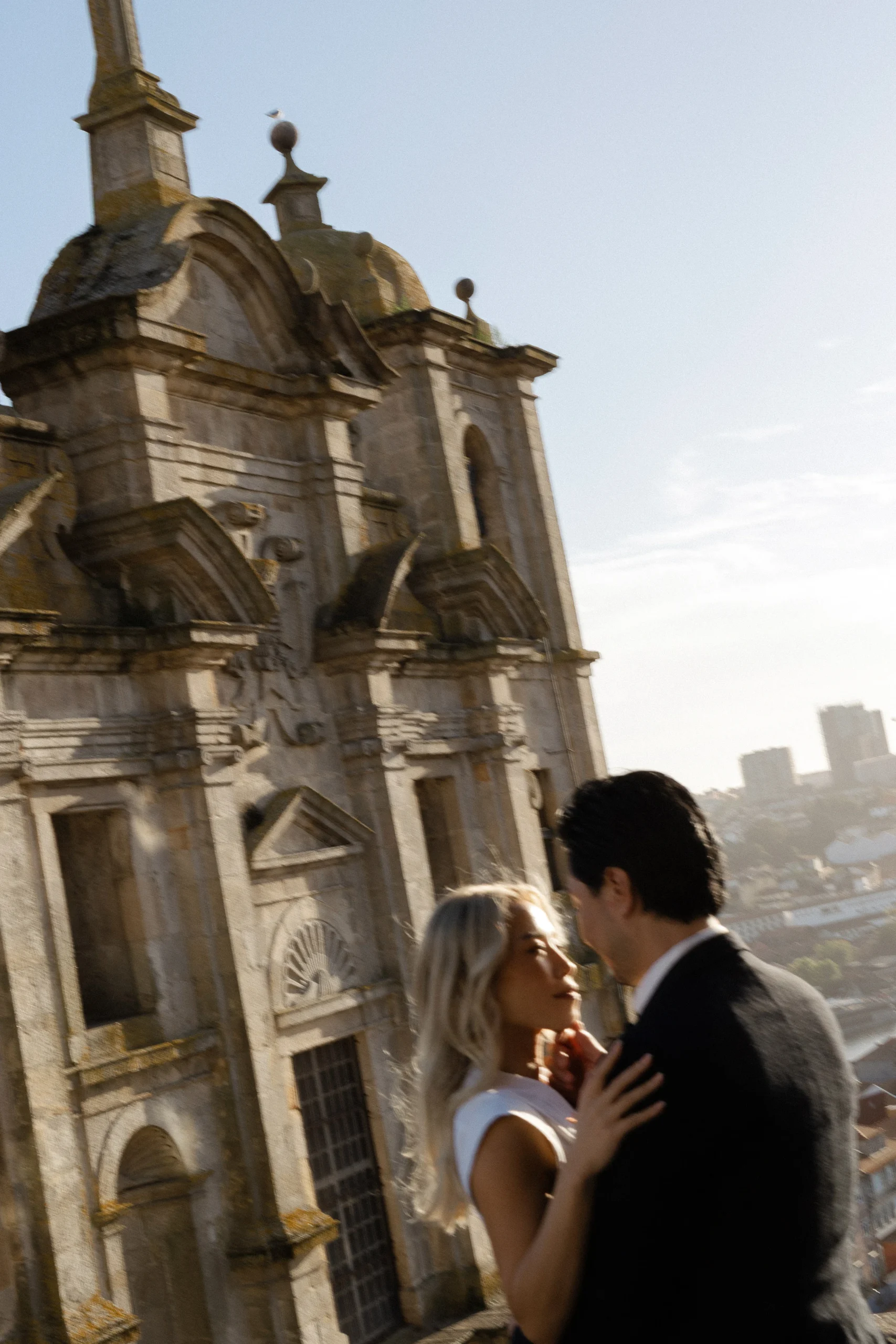 Couple during an engagement session in Porto, Portugal, in warm evening light