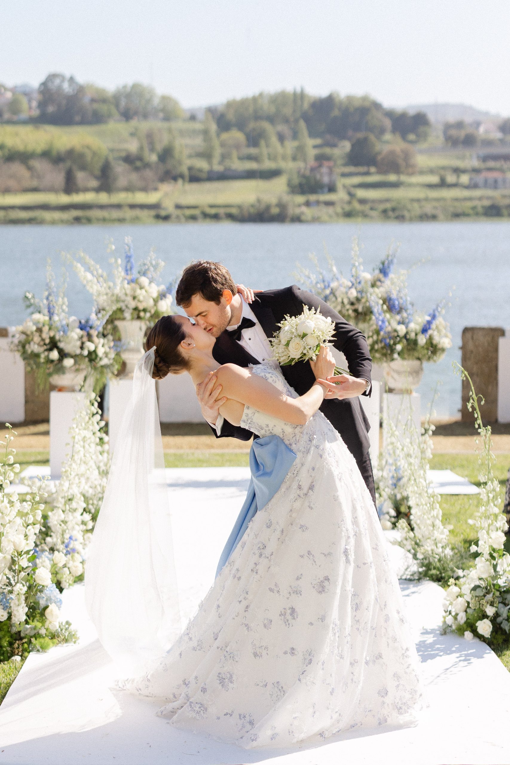 Wedding couple sharing a romantic moment by the water in Portugal